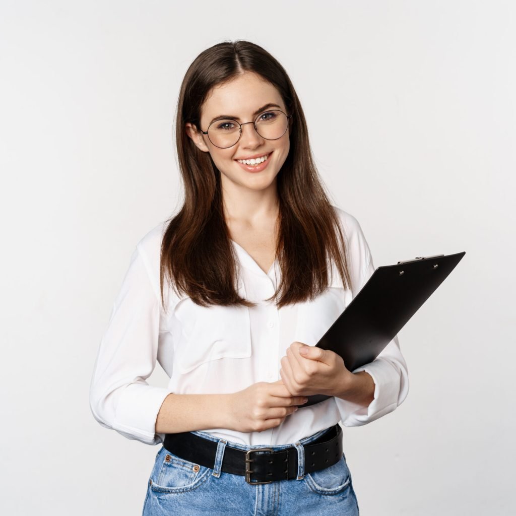 Portrait of corporate woman holding clipboard at work, standing in formal outfit over white background.